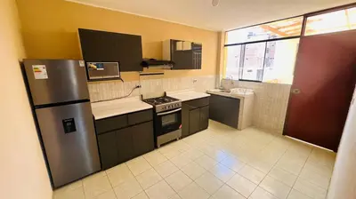 a kitchen with a refrigerator and a stove in it at DEPARTAMENTO Chincha City 1 in Chincha