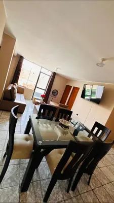 a dining room with a glass table and chairs at DEPARTAMENTO Chincha City 1 in Chincha