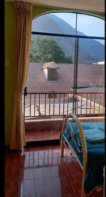 a room with a large window with a view of a mountain at Departamento tranquilo en Condominio in Santa Eulalia