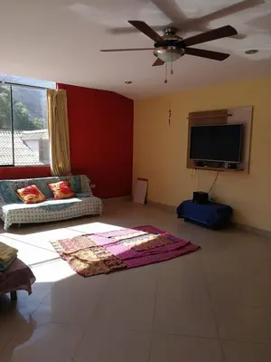 a living room with a couch and a flat screen tv at Departamento tranquilo en Condominio in Santa Eulalia