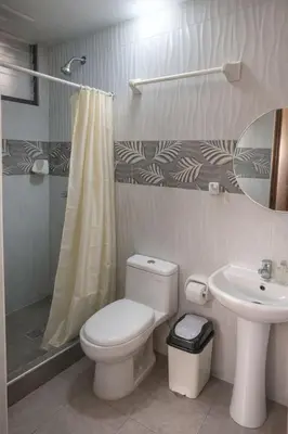 a bathroom with a toilet and a sink at Hospedaje chakana inn in Cusco