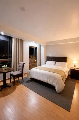 a bedroom with a bed and a desk and a chair at Hospedaje chakana inn in Cusco