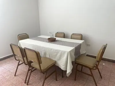 a table with a white table cloth and four chairs at Departamento independiente en Santa Catalina in Lima