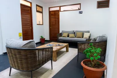 a living room with a couch and a table and chairs at Lama Vista Living 401 in Cusco