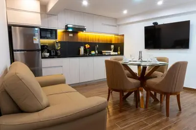 a kitchen and dining room with a table and chairs at Lama Vista Living 401 in Cusco