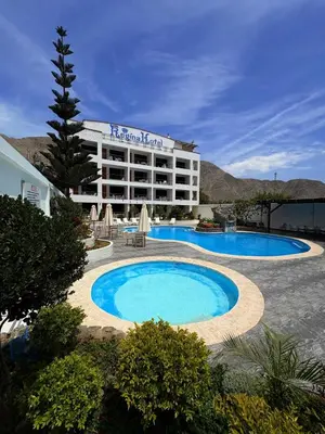 a hotel with a large swimming pool in front of it at Regina Hotel in Lunahuaná