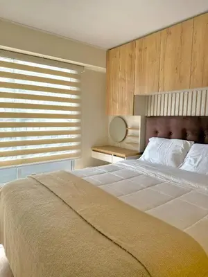 a bedroom with a large bed and a window at Departamento de Estreno en Zona Financiera in Lima