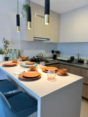 a kitchen with a table with plates and glasses on it at Departamento de Estreno en Zona Financiera in Lima