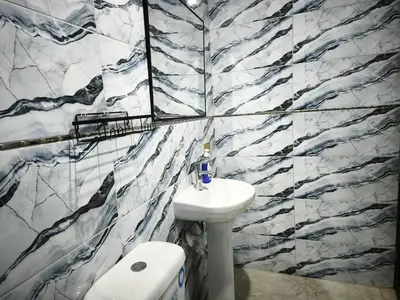 a bathroom with a black and white marble wall at Huaqui House in Ayacucho