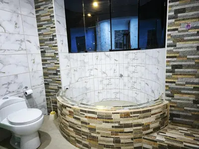a bathroom with a toilet and a bath tub at Huaqui House in Ayacucho