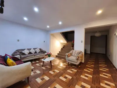 a living room with a couch and a table at Huaqui House in Ayacucho