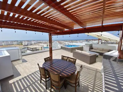 a patio with a table and chairs on a roof at Duplex Condominio Míkonos Asia in Asia