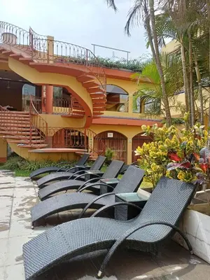 a row of chairs in front of a building at Hostal Sol Y Luna - Cieneguilla in Cieneguilla