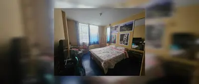 a small bedroom with a bed and a window at Nazcazone in Nazca