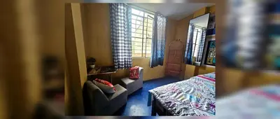 a small bedroom with a bed and a window at Nazcazone in Nazca