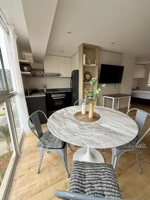 a kitchen with a table and chairs in a room at Departamento San Martin in Lima