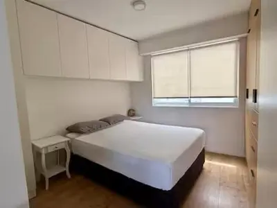 a bedroom with a large white bed and a window at Departamento San Martin in Lima