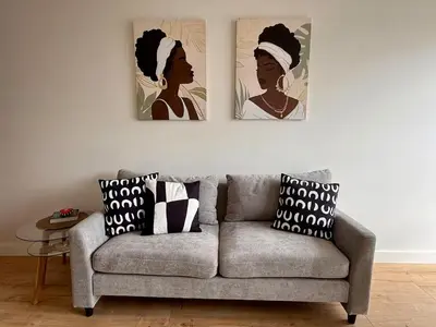 a living room with a couch and two paintings on the wall at Departamento San Martin in Lima