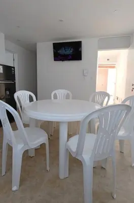 a white table and chairs in a room at Apartamento 301 cerca a la playa in Punta Negra