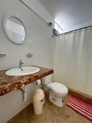 a bathroom with a sink and a toilet and a mirror at Apartamento 302 cerca a la playa in Punta Negra