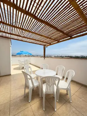 a table and chairs on a balcony with a view of the beach at Apartamento 302 cerca a la playa in Punta Negra