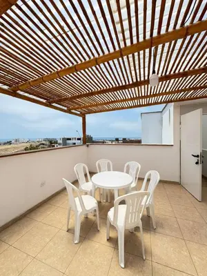 a patio with a table and chairs on a roof at Apartamento 302 cerca a la playa in Punta Negra