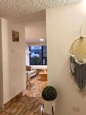 a view of a living room from the hallway at Acogedor departamento en Malecón Balta con Piscina in Lima