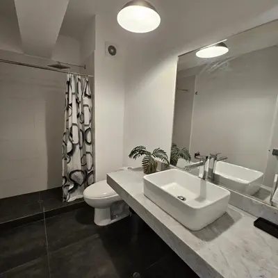 a bathroom with a sink and a toilet and a mirror at PERU STAY Barranco in Lima