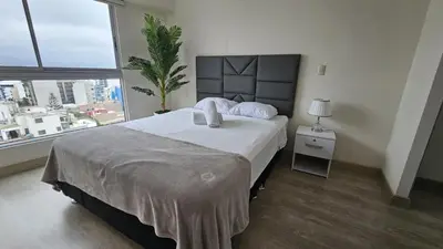 a bedroom with a large bed and a large window at Nordic Barranco by PERU STAY in Lima