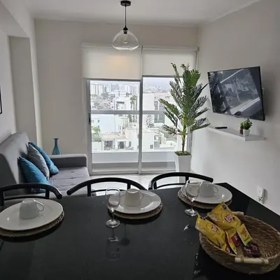 a living room with a table with chairs and a dining room at Nordic Barranco by PERU STAY in Lima