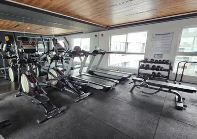 a gym with several treadmills and cardio machines at Nordic Barranco by PERU STAY in Lima