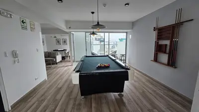 a pool table in the middle of a living room at Nordic Barranco by PERU STAY in Lima