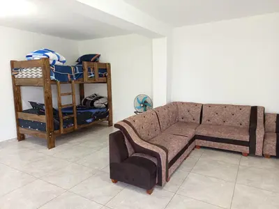 a living room with a couch and a bunk bed at Casa Rústica in Ica