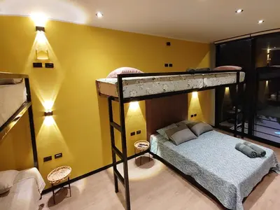 a bedroom with two bunk beds and a yellow wall at Quiet 4BR Villa with Pool & Terrace in Ica