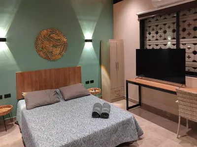 a bedroom with a bed and a flat screen tv at Quiet 4BR Villa with Pool & Terrace in Ica
