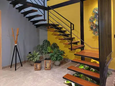 a staircase in a room with potted plants at Quiet 4BR Villa with Pool & Terrace in Ica