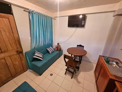 a living room with a green couch and a table at Pantaq hostal in Cusco