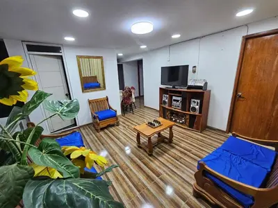 a living room with a couch and a tv at Munay Ayllu- Tu refugio familiar en Huánuco in Huánuco