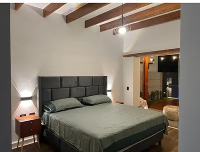 a bedroom with a large bed in a room at Condominio ecológico las gardenias de Asia in Asia