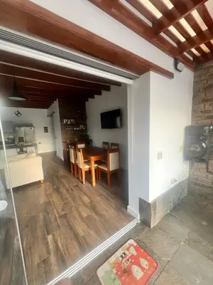 a dining room and living room with a table and chairs at Condominio ecológico las gardenias de Asia in Asia