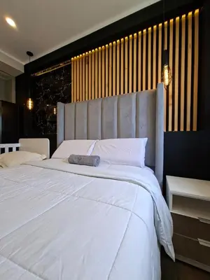 a bedroom with a large white bed with a headboard at Beach House - Besso Beach in Barranca