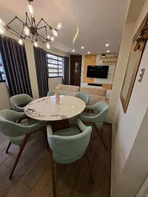 a living room with a table and chairs at Beach House - Besso Beach in Barranca