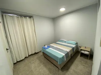 a small bedroom with a bed and a window at Ruta del Oasis - Huacachina in Ica