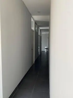a hallway with a white wall and a pillar at Ruta del Oasis - Huacachina in Ica