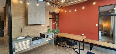 a kitchen with a wooden table and a counter at Quiet 3BR Country Villa whit BBQ in Ica