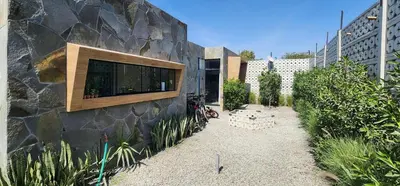 a building with a stone wall with a window on it at Quiet 2BR Villa whit Pool & Games in Ica
