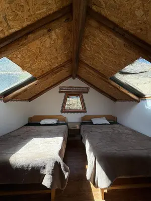 a room with three beds in a attic at Salkantay House in Anta