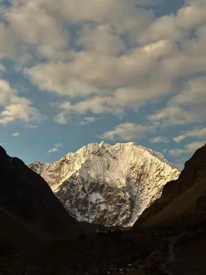a snow covered mountain in the middle of a valley at Salkantay House in Anta
