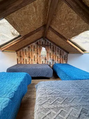 a room with three beds in a attic at Salkantay House in Anta