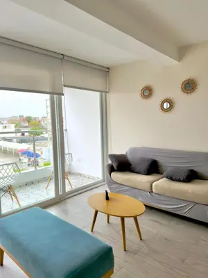 a living room with a couch and a table at Modern apartment a short walk from the boulevard and beach in Punta Hermosa